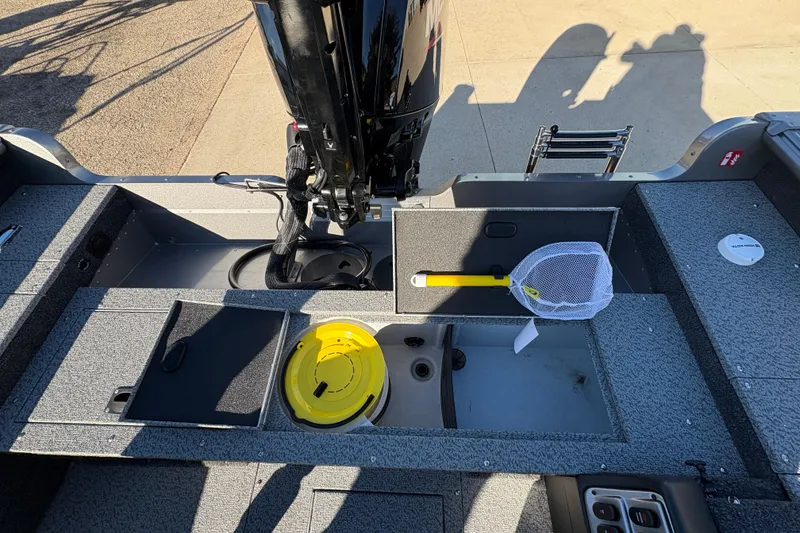 Slide: The Image of 2025 Lund 1875 Pro Guide boat interior with fishing net and storage compartments. - 31