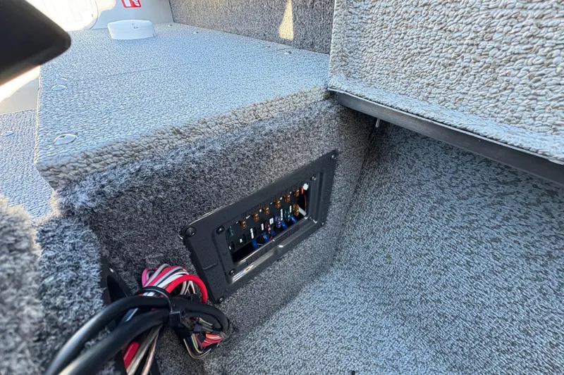 Slide: The Image of 2025 Lund 1875 Pro Guide boat interior with fuse panel and wiring. - 34