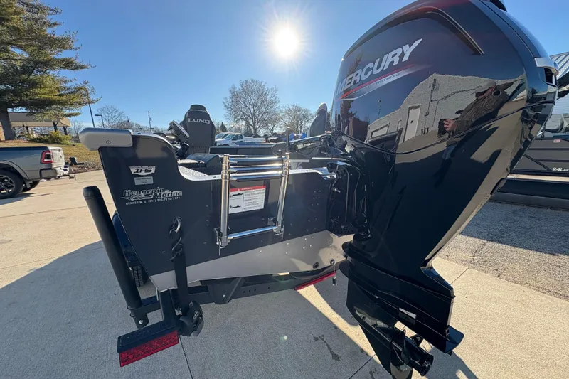 Slide: The Image of 2025 Lund 1875 Pro Guide boat with Mercury engine in sunny outdoor setting. - 36