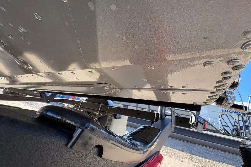 Slide: The Image of 2025 Lund 1875 Pro Guide boat hull on trailer, showcasing riveted construction. - 40