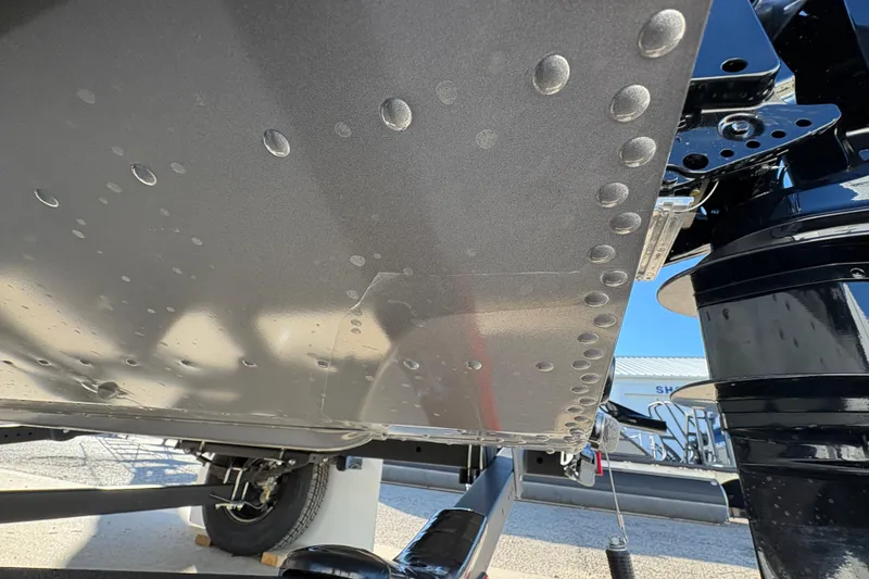 Slide: The Image of 2025 Lund 1875 Pro Guide boat hull with rivets and trailer detail. - 41