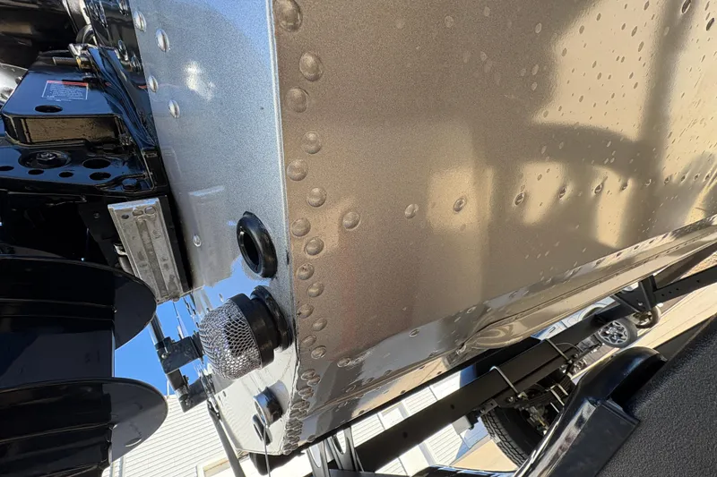 Slide: The Image of 2025 Lund 1875 Pro Guide boat hull close-up with rivets and fittings. - 43