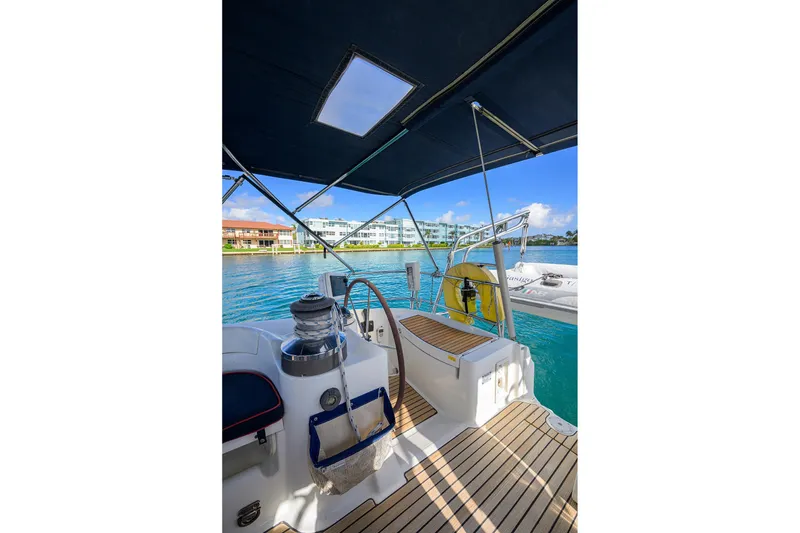 Slide: The Image of Cockpit view of 2003 Beneteau 50 sailboat with scenic waterfront backdrop. - 12