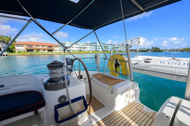 Slide: The Image of Cockpit view of 2003 Beneteau 50 yacht, overlooking serene waterfront and modern buildings. - 13