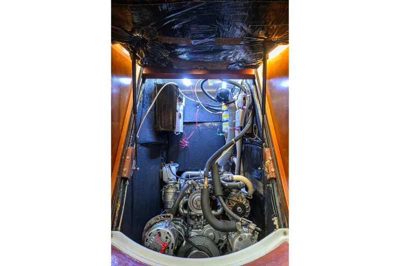 Slide: The Image of Engine compartment of a 2003 Beneteau 50 sailboat, showcasing mechanical components and wiring. - 19