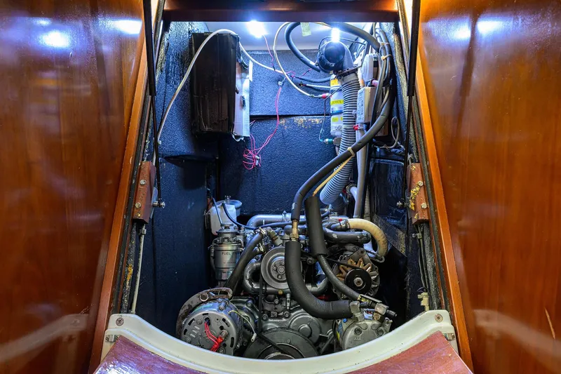 Slide: The Image of Engine room of a 2003 Beneteau 50 sailboat, showcasing mechanical components and wiring. - 20