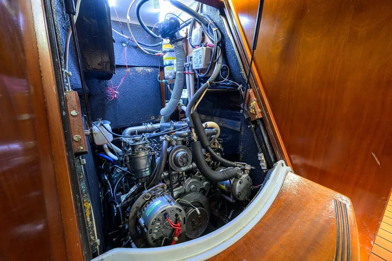 Slide: The Image of Engine room of a 2003 Beneteau 50 sailboat, showcasing detailed mechanical components. - 21