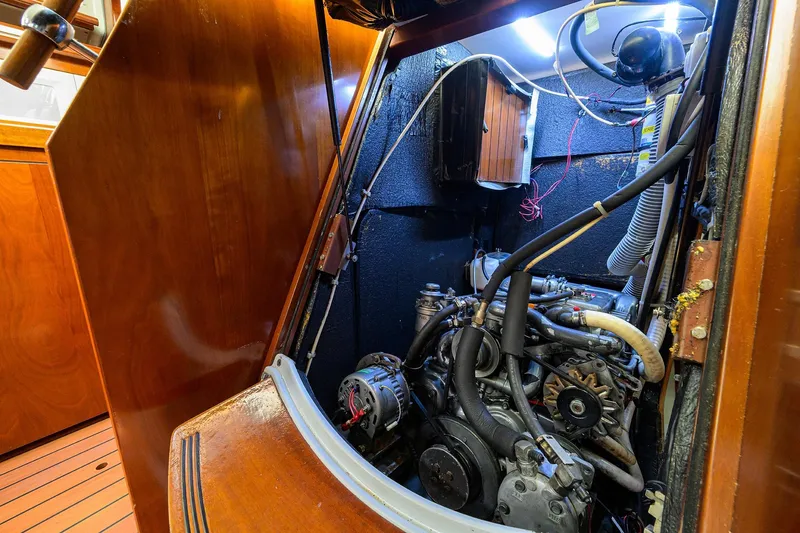 Slide: The Image of Engine room of a 2003 Beneteau 50 sailboat, showcasing mechanical components and wiring. - 22