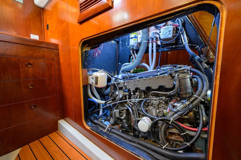 Slide: The Image of Engine compartment of a 2003 Beneteau 50 sailboat, showcasing detailed mechanical components. - 25