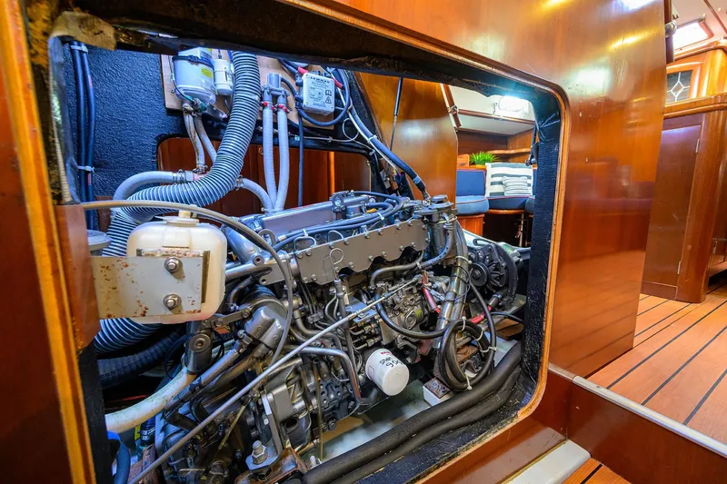 Slide: The Image of Engine room of a 2003 Beneteau 50 yacht, showcasing detailed mechanical components. - 26