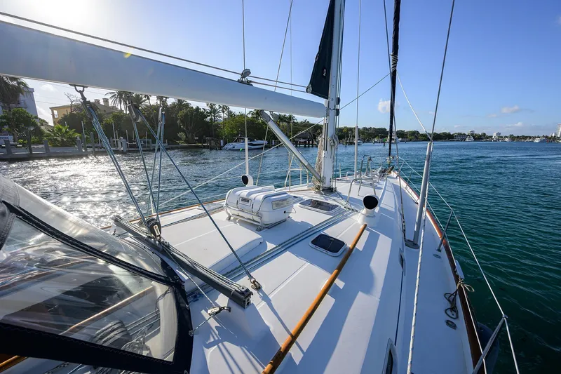 Slide: The Image of Sailing yacht Beneteau 50, 2003 model, cruising on a sunny day near the coastline. - 35