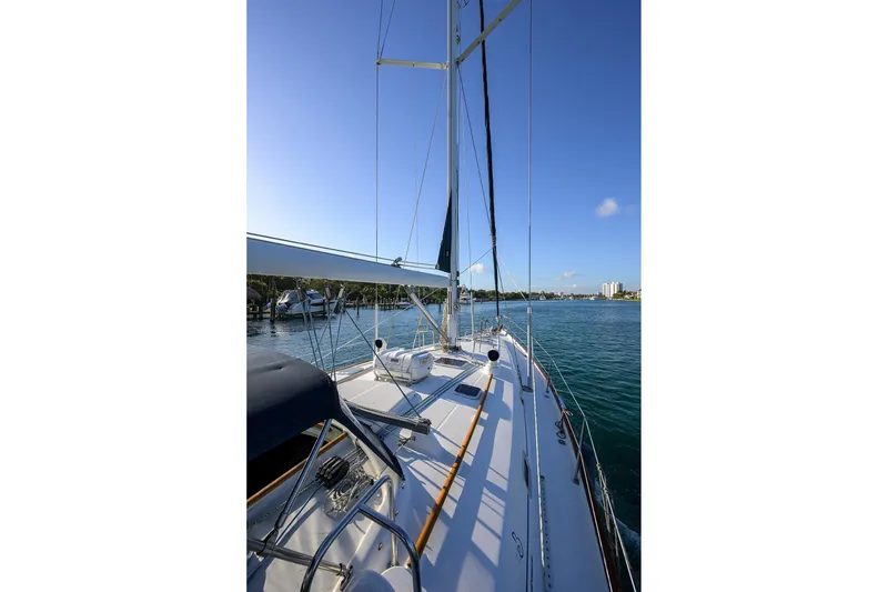 Slide: The Image of 2003 Beneteau 50 sailboat on calm waters under clear blue sky. - 36