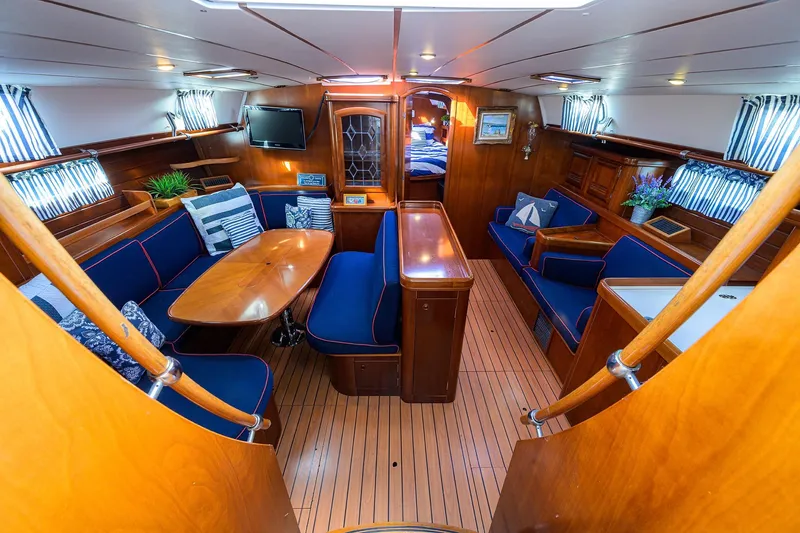 Slide: The Image of Luxurious interior of a 2003 Beneteau 50 yacht with elegant wood finish and blue seating. - 37
