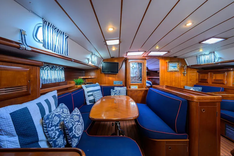 Slide: The Image of Luxurious interior of 2003 Beneteau 50 yacht with elegant wood finish and blue seating. - 39