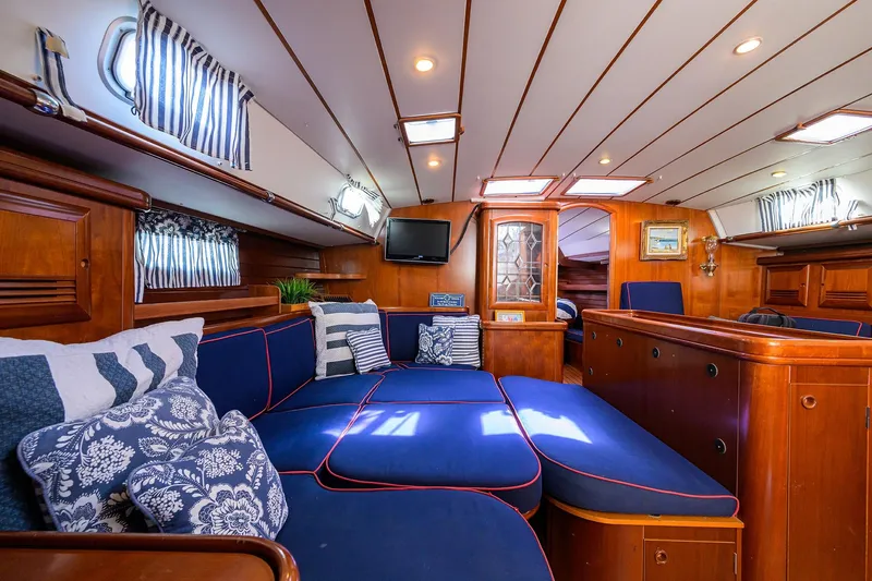 Slide: The Image of Luxurious interior of 2003 Beneteau 50 yacht with blue seating and wooden accents. - 42