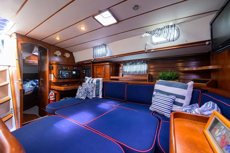 Slide: The Image of Luxurious interior of 2003 Beneteau 50 yacht with blue seating and nautical decor. - 43