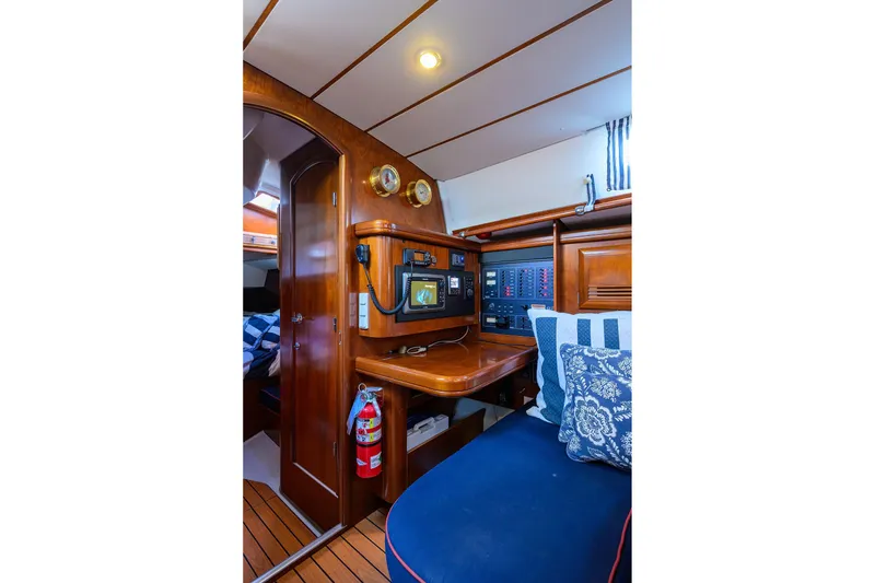 Slide: The Image of Interior of 2003 Beneteau 50 yacht with navigation station and cozy seating area. - 44
