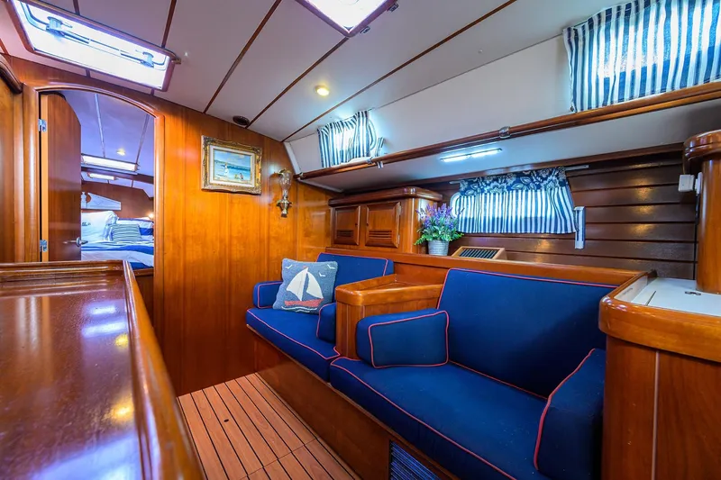 Slide: The Image of Luxurious interior of 2003 Beneteau 50 yacht with blue seating and wooden finishes. - 46