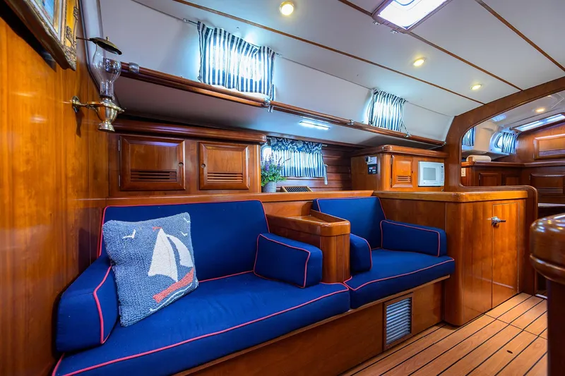 Slide: The Image of Luxurious interior of 2003 Beneteau 50 yacht with blue seating and wooden finishes. - 49