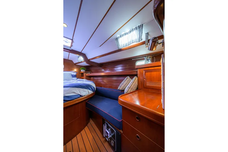Slide: The Image of Luxurious cabin interior of 2003 Beneteau 50 yacht with wood finish and cozy bedding. - 51