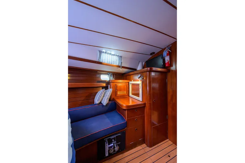 Slide: The Image of Cozy cabin interior of 2003 Beneteau 50 yacht with wooden finish and seating area. - 55