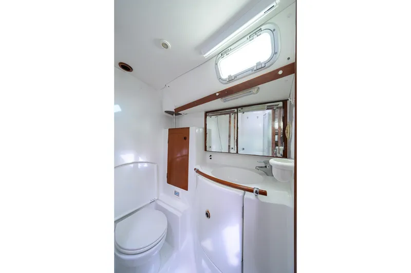 Slide: The Image of Bathroom interior of 2003 Beneteau 50 yacht, featuring sink, toilet, and mirror. - 59