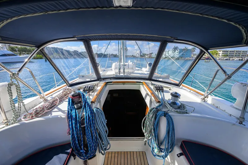 Slide: The Image of Cockpit view of 2003 Beneteau 50 sailboat with ropes and marina backdrop. - 6