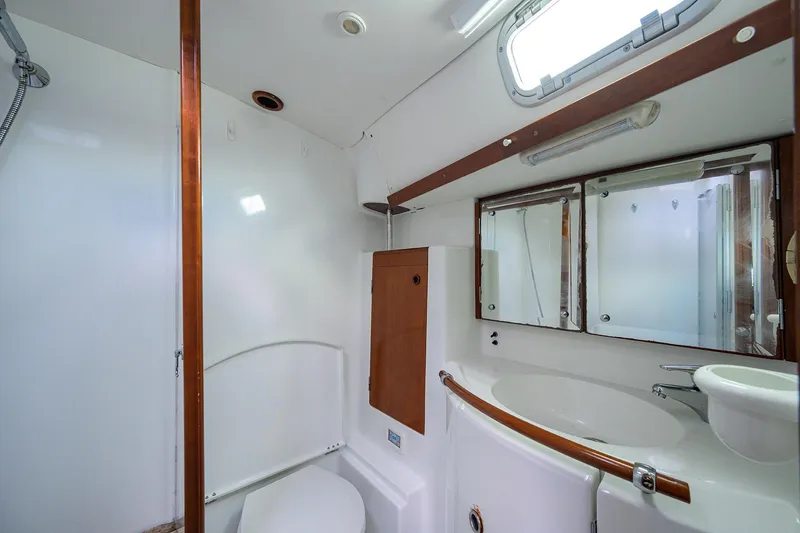 Slide: The Image of Bathroom interior of 2003 Beneteau 50 yacht, featuring sink, mirror, and toilet. - 60