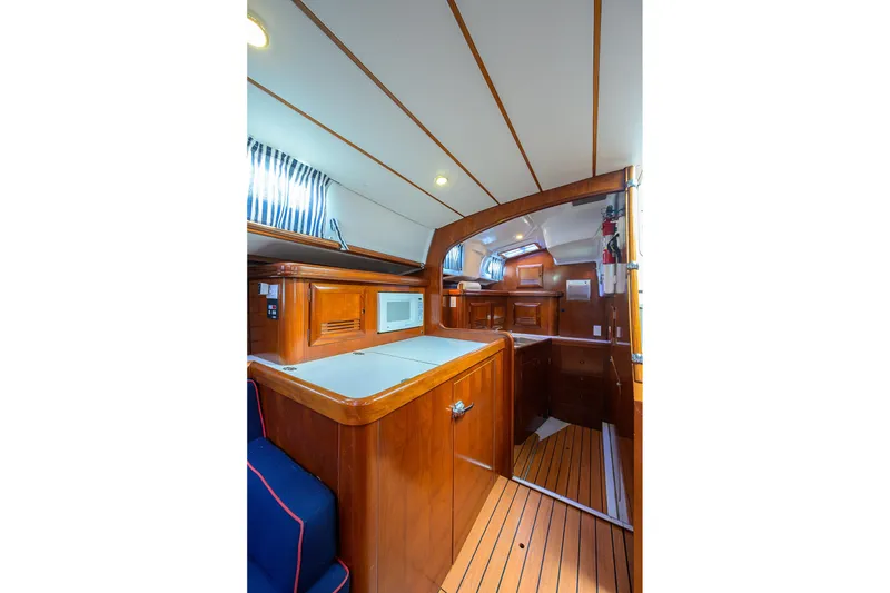 Slide: The Image of Interior of 2003 Beneteau 50 yacht, featuring wooden cabinetry and modern amenities. - 61