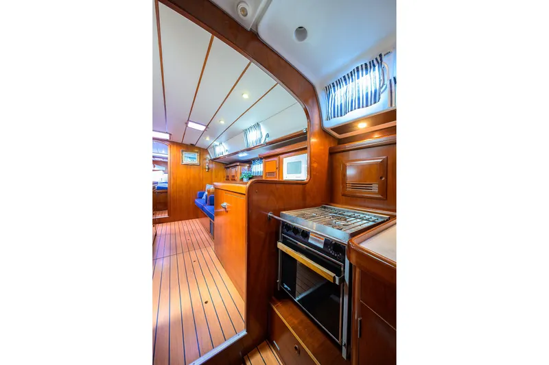 Slide: The Image of Interior of 2003 Beneteau 50 yacht with wooden finish and modern kitchen amenities. - 65