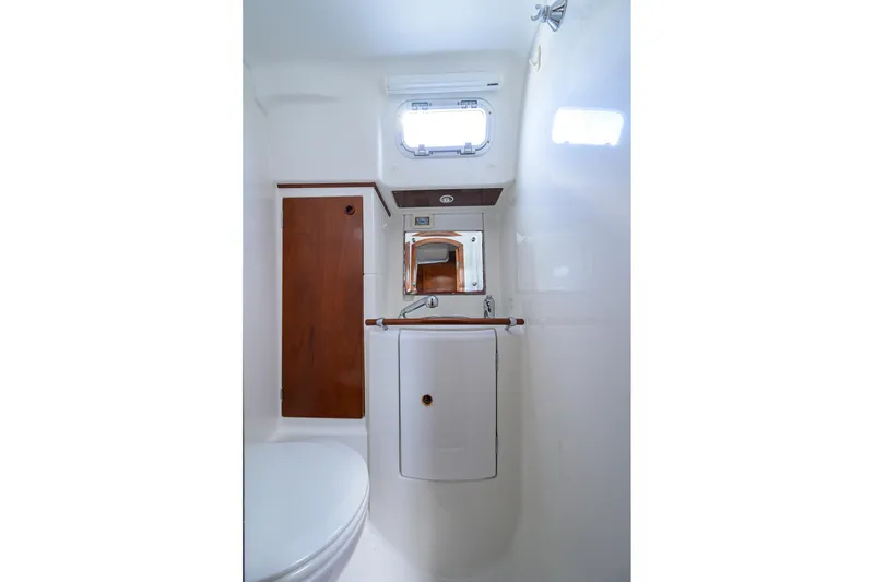 Slide: The Image of Bathroom interior of 2003 Beneteau 50 yacht, featuring compact design and wooden accents. - 70
