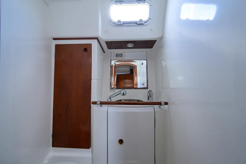 Slide: The Image of Beneteau 50 yacht bathroom, 2003 model, featuring wooden cabinetry and compact sink. - 71
