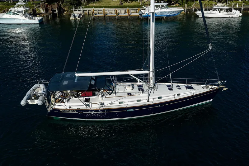 Slide: The Image of 2003 Beneteau 50 sailboat on water, docked with other boats nearby. - 75