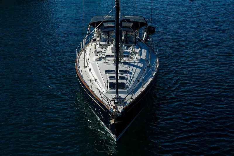 Slide: The Image of Front view of a 2003 Beneteau 50 sailboat on calm blue water. - 79