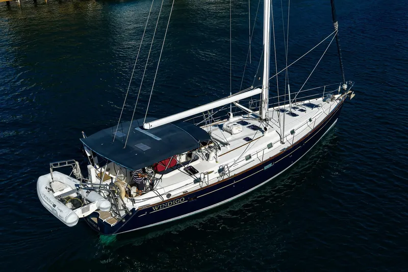 Slide: The Image of 2003 Beneteau 50 sailboat on calm water, featuring sleek design and spacious deck. - 83