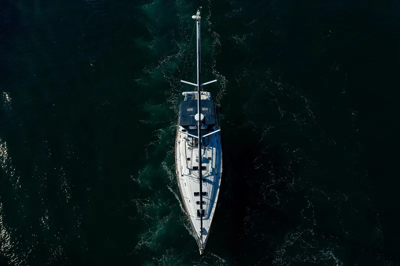 Slide: The Image of Aerial view of 2003 Beneteau 50 sailboat navigating dark waters. - 86