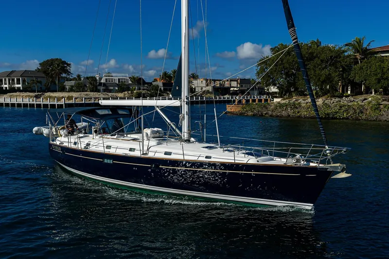 Slide: The Image of 2003 Beneteau 50 sailboat cruising on a sunny day near a coastal area. - 87