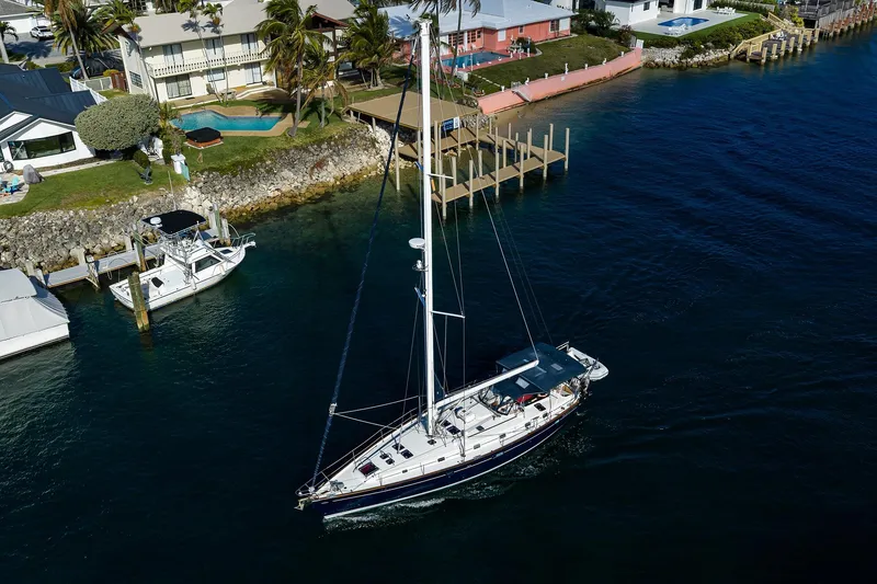 Slide: The Image of Aerial view of 2003 Beneteau 50 sailboat near waterfront homes and docks. - 96