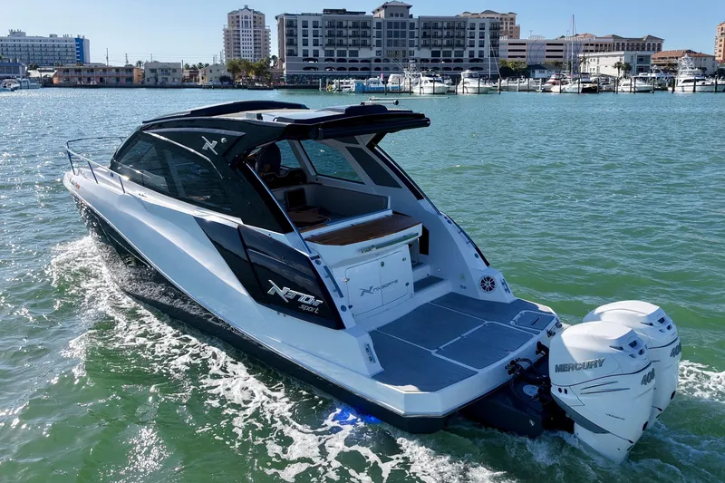 The Image of 2024 NX Boats 370 HT cruising on a sunny day in coastal waters. - 0