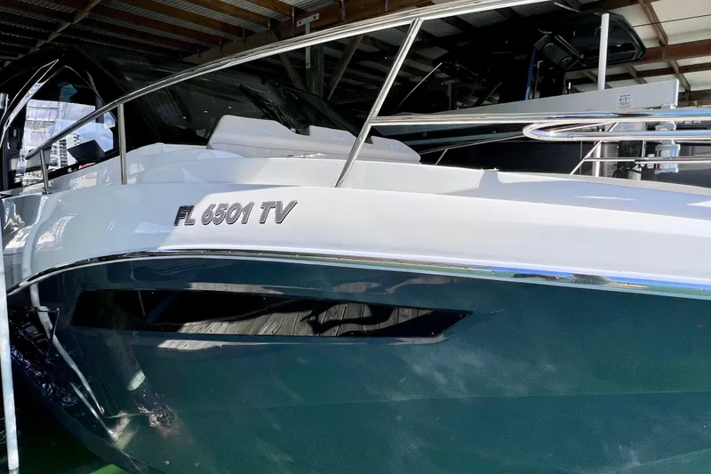 Slide: The Image of 2024 NX Boats 370 HT in a marina, showcasing sleek design and modern features. - 11