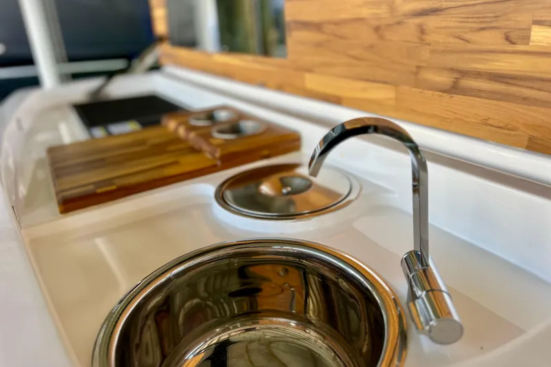 Slide: The Image of 2024 NX Boats 370 HT kitchen area with modern sink and wooden accents. - 18