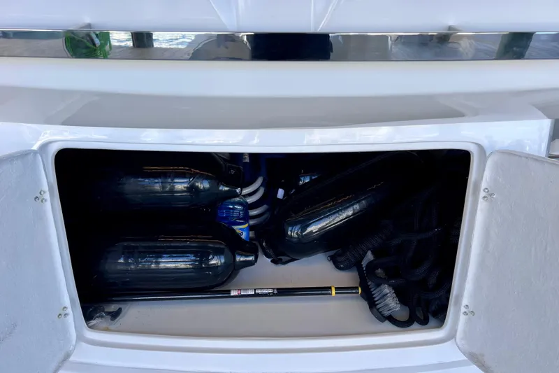 Slide: The Image of Storage compartment of 2024 NX Boats 370 HT with fenders and equipment. - 19