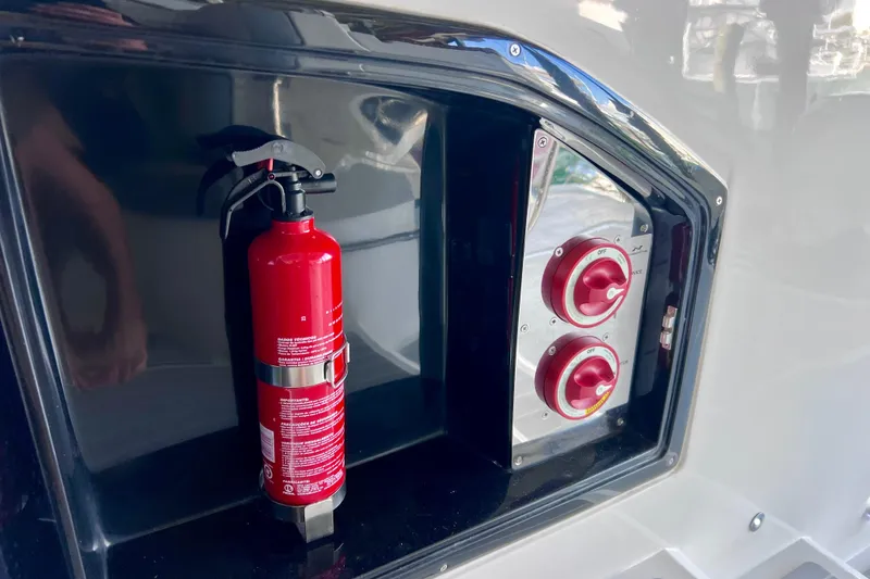 Slide: The Image of Fire extinguisher and control panel on 2024 NX Boats 370 HT. - 23