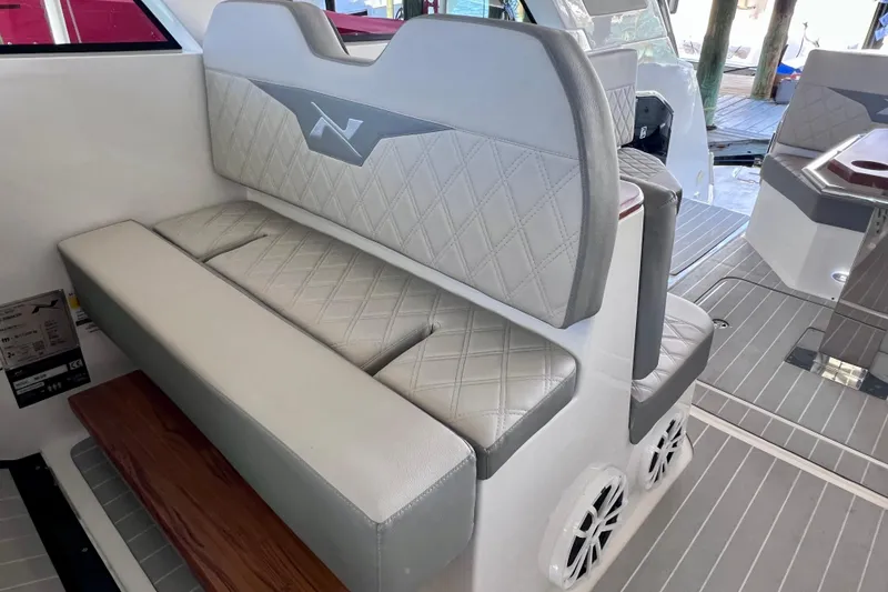 Slide: The Image of 2024 NX Boats 370 HT interior with elegant diamond-stitched seating and modern design. - 31