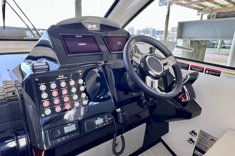 Slide: The Image of 2024 NX Boats 370 HT helm with advanced controls and dual displays. - 37
