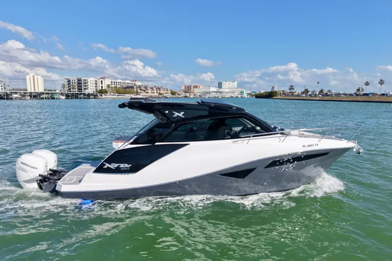 Slide: The Image of 2024 NX Boats 370 HT cruising on a sunny day with Mercury outboard engine. - 4