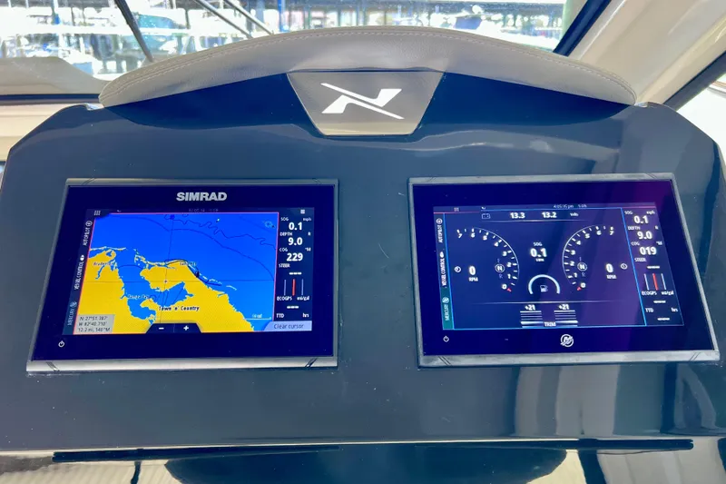 Slide: The Image of Dashboard of 2024 NX Boats 370 HT with navigation and control screens. - 40