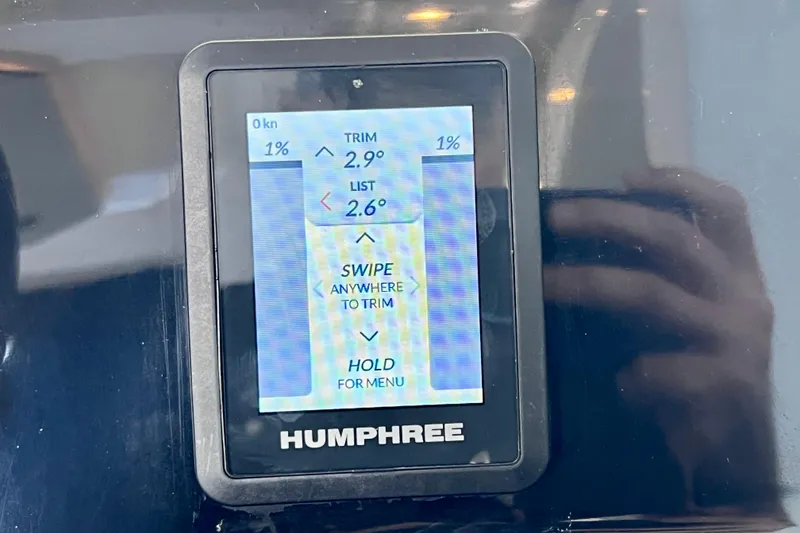 Slide: The Image of Display screen on 2024 NX Boats 370 HT showing trim and list settings. - 44