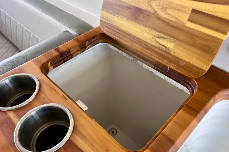 Slide: The Image of Open wooden compartment with cup holders on NX Boats 370 HT, 2024 model. - 47
