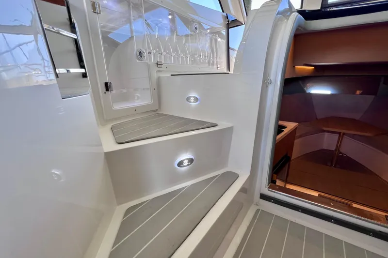 Slide: The Image of 2024 NX Boats 370 HT interior with illuminated steps and modern design. - 48